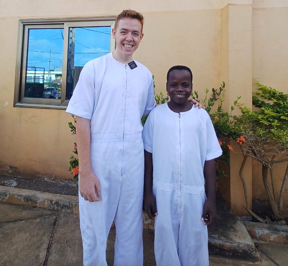 Two men in white outfits standing in front of a building

AI-generated content may be incorrect.