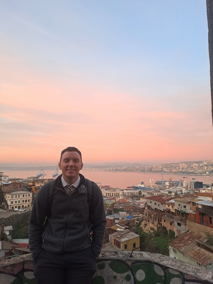 A person standing on a ledge with a city in the background

AI-generated content may be incorrect.