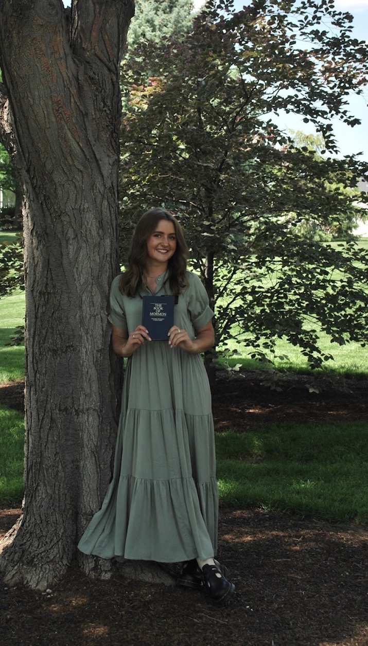 A person in a long dress holding a book

AI-generated content may be incorrect.