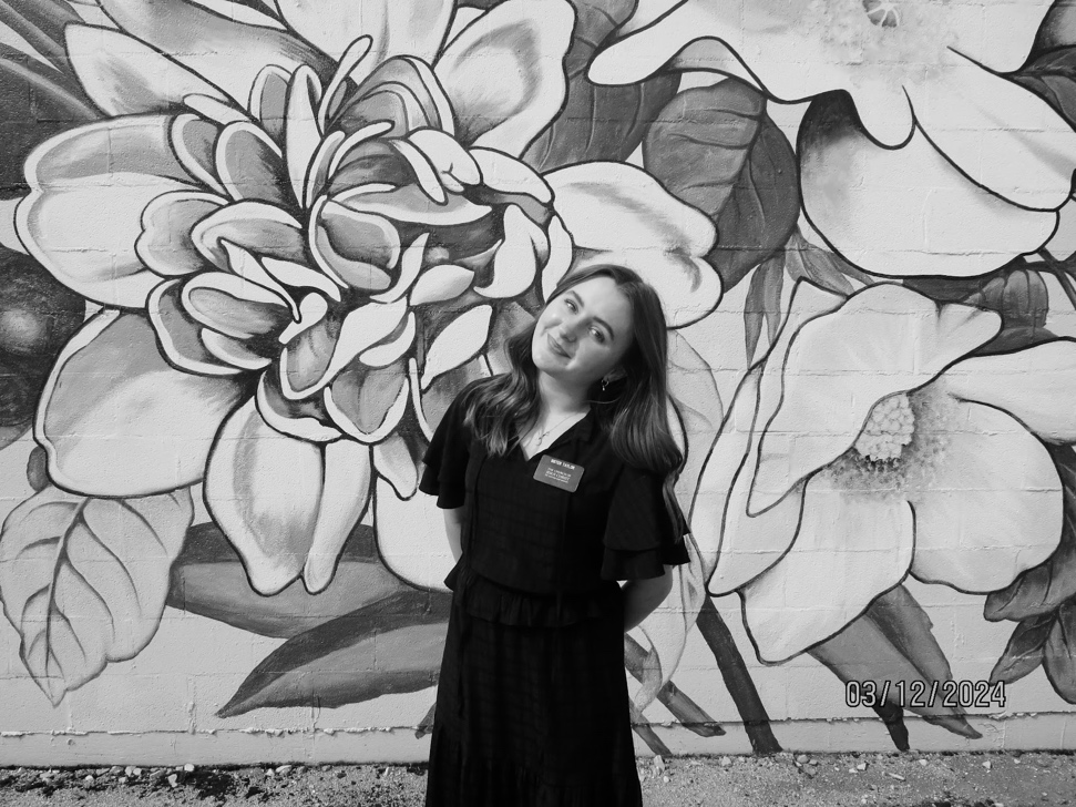 A person standing in front of a mural of flowers

AI-generated content may be incorrect.