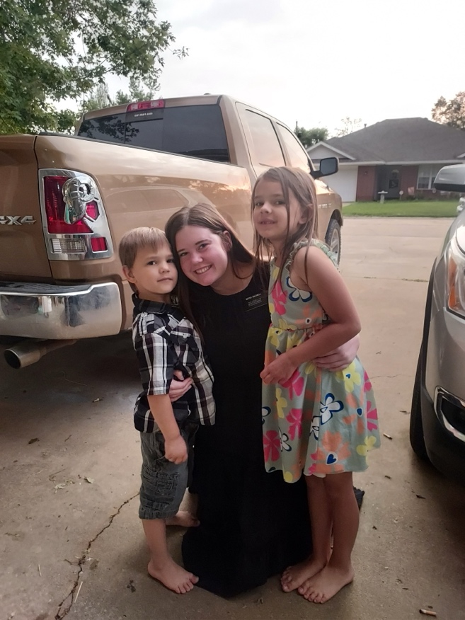 A person and two children posing for a picture

AI-generated content may be incorrect.