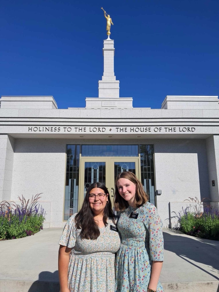 Two women standing in front of a building

AI-generated content may be incorrect.