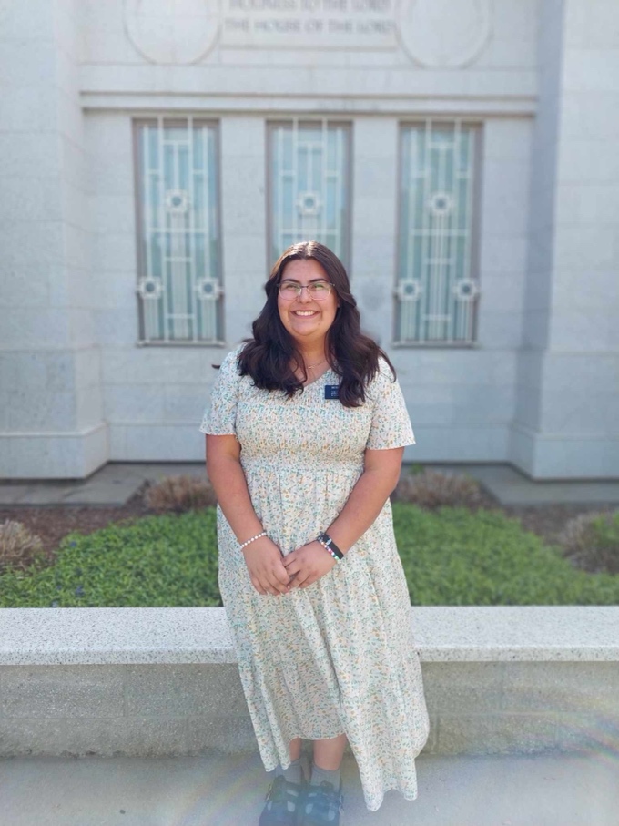 A person in a dress standing in front of a building

AI-generated content may be incorrect.