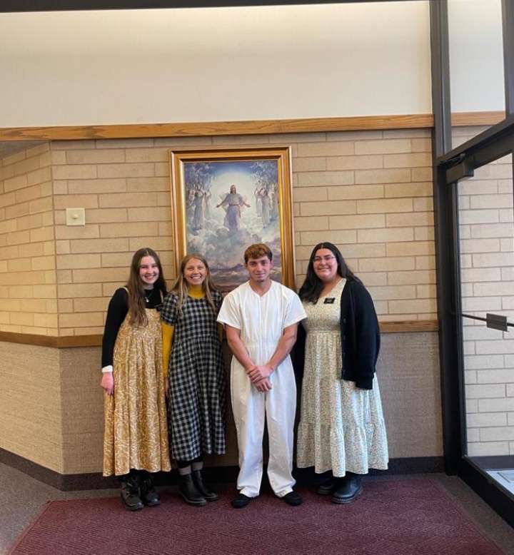 A group of people standing in front of a painting

AI-generated content may be incorrect.