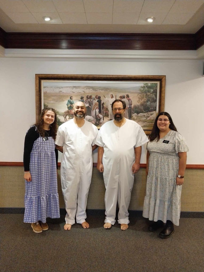A group of people standing in front of a painting

AI-generated content may be incorrect.